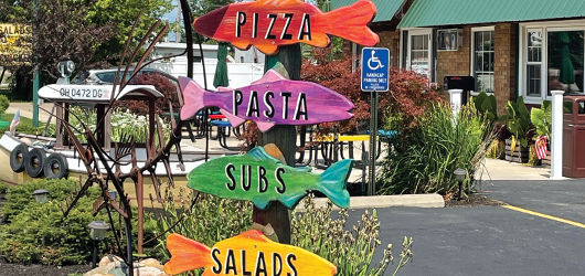 Colorfully painted fish direct customers to the store